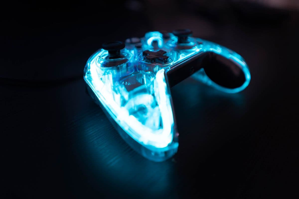 A game controller lit by neon light